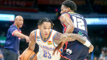 Tre Mann #23 of the Oklahoma City Thunder drives past Craig Randall II #12 of the Adelaide 36ers during the third quarter at Paycom Center on October 06, 2022 in Oklahoma City, Oklahoma. (Photo by Ian Maule/Getty Images)