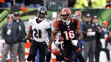 Dec 29, 2013; Cincinnati, OH, USA; Cincinnati Bengals wide receiver Andrew Hawkins (16) runs the ball against Baltimore Ravens cornerback Lardarius Webb (21) in the second half at Paul Brown Stadium. Cincinnati defeated Baltimore 34-17. Mandatory Credit: Mark Zerof-USA TODAY Sports