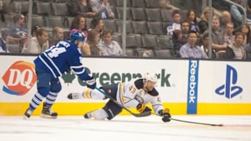 Sep 25, 2015; Toronto, Ontario, CAN; Toronto Maple Leafs player Mitch Marner (84) brings down Buffalo Sabres player Daniel Catenacci (43) during the second period of game against Buffalo Sabres at Air Canada Centre. Mandatory Credit: Peter Llewellyn-USA TODAY Sports