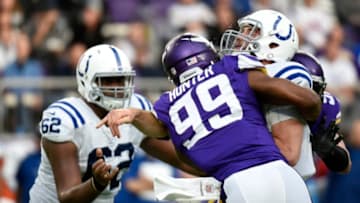 MINNEAPOLIS, MN - DECEMBER 18: Andrew Luck #12 of the Indianapolis Colts is hit by Danielle Hunter #99 of the Minnesota Vikings after throwing the ball in the first half of the game on December 18, 2016 at US Bank Stadium in Minneapolis, Minnesota. (Photo by Hannah Foslien/Getty Images)