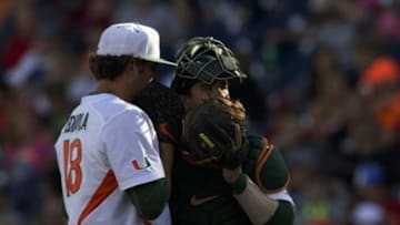 Jun 15, 2015; Omaha, NE, USA; Miami Hurricanes catcher Garrett Kennedy (40) talks to pitcher Michael Mediavilla (18) against the Arkansas Razorbacks during the seventh inning at TD Ameritrade Park. Miami won 4-3. Mandatory Credit: Bruce Thorson-USA TODAY Sports