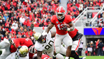 ATHENS, GA - NOVEMBER 24: Elijah Holyfield #13 of the Georgia Bulldogs carries the ball against the Georgia Tech Yellow Jackets on November 24, 2018 at Sanford Stadium in Athens, Georgia. (Photo by Scott Cunningham/Getty Images)