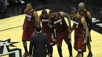Jun 5, 2014; San Antonio, TX, USA; Miami Heat forward LeBron James (6) reacts after getting injured in the fourth quarter while being helped to the bench by teammates against the San Antonio Spurs in game one of the 2014 NBA Finals at AT&T Center. The Spurs beat the Heat 110-95. Mandatory Credit: Brendan Maloney-USA TODAY Sports