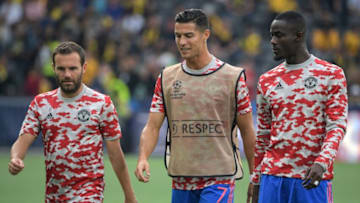 Manchester United's Portuguese striker Cristiano Ronaldo (C) walks with Manchester United's Spanish midfielder Juan Mata (L) and Manchester United's Ivorian defender Eric Bailly (R). (Photo by SEBASTIEN BOZON/AFP via Getty Images)