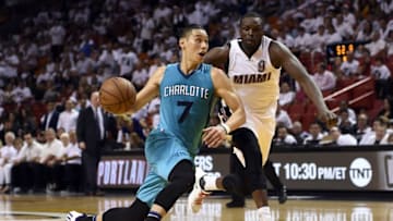 Apr 20, 2016; Miami, FL, USA;Charlotte Hornets guard Jeremy Lin (7) dribbles the ball as Miami Heat forward Luol Deng (9) defends in game two of the first round of the NBA Playoffs during the fourth quarter at American Airlines Arena. The Heat won 115-103. Mandatory Credit: Steve Mitchell-USA TODAY Sports