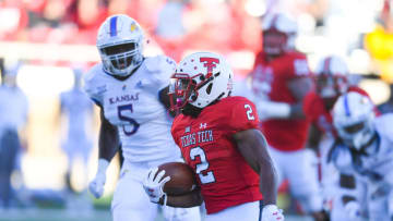 LUBBOCK, TX - OCTOBER 20: Demarcus Felton #2 of the Texas Tech Red Raiders runs past Azur Kamara #5 of the Kansas Jayhawks and will score a touchdown during the second half of the game on October 20, 2018 at Jones AT&T Stadium in Lubbock, Texas. Texas Tech defeated Kansas 48-16. (Photo by John Weast/Getty Images)