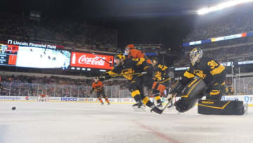 PHILADELPHIA, PA - FEBRUARY 23: Bryan Rust #17 of the Pittsburgh Penguins and Scott Laughton #21 of the Philadelphia Flyers skate after the rebound during the 2019 Coors Light NHL Stadium Series game between the Pittsburgh Penguins and the Philadelphia Flyers at Lincoln Financial Field on February 23, 2019 in Philadelphia, Pennsylvania. (Photo by Brian Babineau/NHLI via Getty Images)