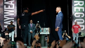 TORONTO, CANADA - JULY 12: (L-R) Floyd Mayweather Jr. interacts with Conor McGregor on stage as they face off during the Floyd Mayweather Jr. v Conor McGregor World Press Tour event at Budweiser Stage on July 12, 2017 in Toronto, Ontario, Canada. (Photo by Jeff Bottari/Zuffa LLC/Zuffa LLC via Getty Images)