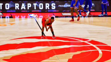 TAMPA, FLORIDA - DECEMBER 31: Kyle Lowry #7 of the Toronto Raptors stretches on center court before tip-off against the New York Knicks at Amalie Arena on December 31, 2020 in Tampa, Florida. NOTE TO USER: User expressly acknowledges and agrees that, by downloading and or using this photograph, User is consenting to the terms and conditions of the Getty Images License Agreement. (Photo by Julio Aguilar/Getty Images)