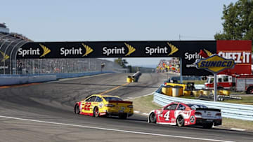 Aug 9, 2015; Watkins Glen, NY, USA; Sprint Cup Series driver Joey Logano (22) passes driver Kevin Harvick (4) on the final turn of the final lap to win the the Cheez-It 355 at Watkins Glen International. Mandatory Credit: Kevin Hoffman-USA TODAY Sports
