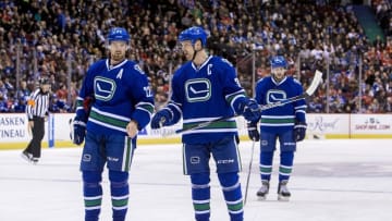 Nov 21, 2015; Vancouver, British Columbia, CAN; Vancouver Canucks forward Daniel Sedin (22) and center Henrik Sedin (33) react against the Chicago Blackhawks at Rogers Arena. Mandatory Credit: Bob Frid-USA TODAY Sports