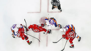 Apr 19, 2023; Raleigh, North Carolina, USA; Carolina Hurricanes center Derek Stepan (21) center Paul Stastny (26) center Jack Drury (18) and New York Islanders center Casey Cizikas (53) left wing Matt Martin (17) and defenseman Scott Mayfield (24) face off against each other during the first period and in game two of the first round of the 2023 Stanley Cup Playoffs at PNC Arena. Mandatory Credit: James Guillory-USA TODAY Sports