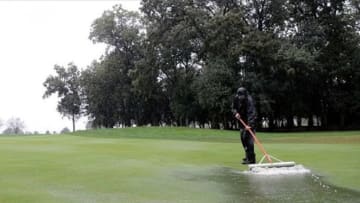 Sep 15, 2013; Lake Forest, IL, USA; Jeff Soukup clears water off the fairway of the 1st hole during the fourth round of the BMW Championship at Conway Farms Golf Club. Mandatory Credit: Reid Compton-USA TODAY Sports