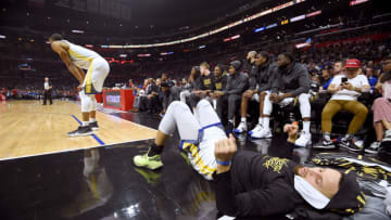 LOS ANGELES, CALIFORNIA - APRIL 18: Stephen Curry #30 of the Golden State Warriors watches play against the LA Clippers lying down on the court during Game Two of Round One of the 2019 NBA Playoffs at Staples Center on April 18, 2019 in Los Angeles, California. (Photo by Harry How/Getty Images) NOTE TO USER: User expressly acknowledges and agrees that, by downloading and or using this photograph, User is consenting to the terms and conditions of the Getty Images License Agreement.