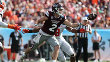 Jan 2, 2023; Tampa, FL, USA; Mississippi State Bulldogs quarterback Will Rogers (2) hands the ball off as Illinois Fighting Illini linebacker Tarique Barnes (8) pressures during the first half in the 2023 ReliaQuest Bowl at Raymond James Stadium. Mandatory Credit: Kim Klement-USA TODAY Sports