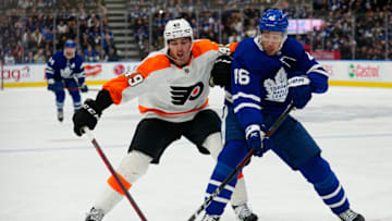 Apr 19, 2022; Toronto, Ontario, CAN; Philadelphia Flyers forward Noah Cates (49) and Toronto Maple Leafs forward Ilya Lyubushkin (46) battle for the puck during the second period at Scotiabank Arena. Mandatory Credit: John E. Sokolowski-USA TODAY Sports