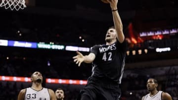 Jan 12, 2014; San Antonio, TX, USA; Minnesota Timberwolves forward Kevin Love (42) drives to the basket as San Antonio Spurs forward Boris Diaw (33) looks on during the second half at AT