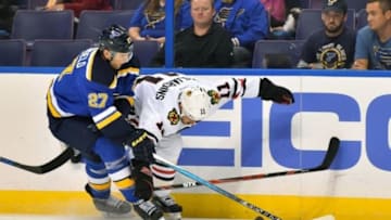 Oct 1, 2015; St. Louis, MO, USA; St. Louis Blues defenseman Alex Pietrangelo (27) and Chicago Blackhawks center Andrew Desjardins (11) battle control of the puck during the first period at Scottrade Center. Mandatory Credit: Jasen Vinlove-USA TODAY Sports