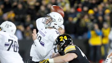 IOWA CITY, IOWA- NOVEMBER 10: Quarterback Clayton Thorson #18 of the Northwestern Wildcats throws under pressure in the second half from defensive end Parker Hesse #40 of the Iowa Hawkeyes, on November 10, 2018 at Kinnick Stadium, in Iowa City, Iowa. (Photo by Matthew Holst/Getty Images)
