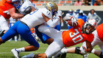 STILLWATER, OK - SEPTEMBER 19: Running back Chuba Hubbard #30 of the Oklahoma State Cowboys pushes past a tackle to score a touchdown against safety Lamar Mullins #13 of the Tulsa Golden Hurricanes in the fourth quarter on September 19, 2020 at Boone Pickens Stadium in Stillwater, Oklahoma. OSU won 16-7. (Photo by Brian Bahr/Getty Images)
