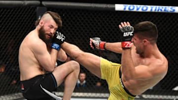 PHOENIX, ARIZONA - FEBRUARY 17: (R-L) Vicente Luque kicks Bryan Barberena in their welterweight bout during the UFC Fight Night event at Talking Stick Resort Arena on February 17, 2019 in Phoenix, Arizona. (Photo by Josh Hedges/Zuffa LLC/Zuffa LLC via Getty Images)