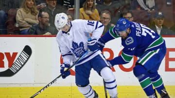 VANCOUVER, BC - MARCH 6: Tanner Pearson #70 of the Vancouver Canucks checks Mitchell Marner #16 of the Toronto Maple Leafs during their NHL game at Rogers Arena March 6, 2019 in Vancouver, British Columbia, Canada. (Photo by Jeff Vinnick/NHLI via Getty Images)