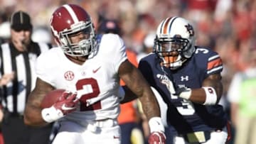 Nov 28, 2015; Auburn, AL, USA; Alabama Crimson Tide running back Derrick Henry (2) runs the ball as Auburn Tigers defensive back Jonathan Jones (3) during the first quarter at Jordan Hare Stadium. Mandatory Credit: Shanna Lockwood-USA TODAY Sports