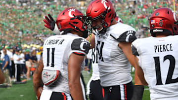 Cincinnati Bearcats tight end Leonard Taylor and offensive lineman Lorenz Metz celebrate after a touchdown against Notre Dame Fighting Irish. USA Today.