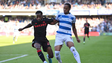 LONDON, ENGLAND - SEPTEMBER 17: Chris Willock of Queens Park Rangers tackles Tariqe Fosu of Stoke City during the Sky Bet Championship between Queens Park Rangers and Stoke City at Loftus Road on September 17, 2022 in London, England. (Photo by Justin Setterfield/Getty Images)