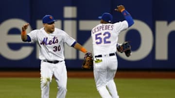 Jun 21, 2016; New York City, NY, USA; New York Mets left fielder Michael Conforto (30) and center fielder Yoenis Cespedes (52) react after defeating the Kansas City Royals 2-1 at Citi Field. Mandatory Credit: Noah K. Murray-USA TODAY Sports