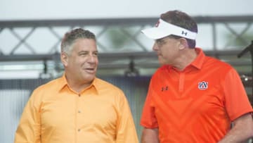 Auburn footballmen's basketball coach Bruce Pearl (left) and football coach Gus Malzahn (right) during an event at Toomer's Corner.635649918952088537 041815auburnadaytreesandconcert13