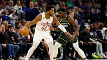 MINNEAPOLIS, MN - JANUARY 14: Donovan Mitchell #45 of the Cleveland Cavaliers dribbles the ball while Anthony Edwards #1 of the Minnesota Timberwolves defends in the third quarter of the game at Target Center on January 14, 2022 in Minneapolis, Minnesota. The Timberwolves defeated the Cavaliers 110-102. NOTE TO USER: User expressly acknowledges and agrees that, by downloading and or using this Photograph, user is consenting to the terms and conditions of the Getty Images License Agreement. (Photo by David Berding/Getty Images)