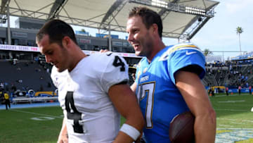 CARSON, CA - OCTOBER 07: Philip Rivers #17 of the Los Angeles Chargers laughs with Derek Carr #4 of the Oakland Raiders after a 26-10 Charger win at StubHub Center on October 7, 2018 in Carson, California. (Photo by Harry How/Getty Images)