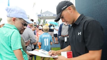 ST. LOUIS, MO - AUGUST 07: Jordan Spieth of the United States signs his autograph for a fan during a practice round prior to the 2018 PGA Championship at Bellerive Country Club on August 7, 2018 in St. Louis, Missouri. (Photo by Jamie Squire/Getty Images)