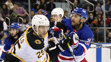 NEW YORK, NEW YORK - OCTOBER 05: Brandon Carlo #25 of the Boston Bruins slows up Barclay Goodrow #21 of the New York Rangers at Madison Square Garden on October 05, 2022 in New York City. The Bruins defeated the Rangers 5-4. (Photo by Bruce Bennett/Getty Images)
