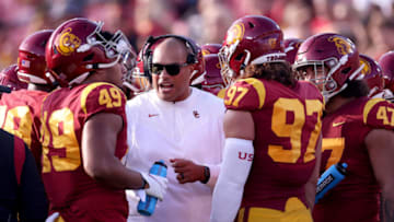 LOS ANGELES, CALIFORNIA - OCTOBER 30: Defensive Line Coach Vic So'oto of the USC Trojans speaks to his players during a timeout during the first half against the Arizona Wildcats at Los Angeles Memorial Coliseum on October 30, 2021 in Los Angeles, California. (Photo by Harry How/Getty Images)