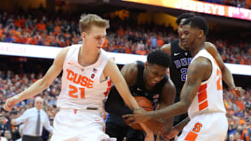 SYRACUSE, NY - FEBRUARY 23: Marek Dolezaj #21 of the Syracuse Orange and Frank Howard (R) reach for the ball controlled by RJ Barrett (C) of the Duke Blue Devils during the second half at the Carrier Dome on February 23, 2019 in Syracuse, New York. Duke defeated Syracuse 75-65. (Photo by Rich Barnes/Getty Images)