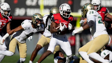 Cincinnati Bearcats running back Charles McClelland runs downfield as South Florida Bulls defense chases him in the third quarter. The Enquirer.