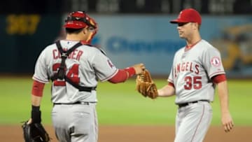 Sep 23, 2014; Oakland, CA, USA; Los Angeles Angels catcher Hank Conger (24) visits the mound to speak with Los Angeles Angels relief pitcher Wade LeBlanc (35) during the fourth inning of the game against the Oakland Athletics at O.co Coliseum. Mandatory Credit: Ed Szczepanski-USA TODAY Sports