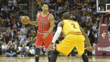 May 12, 2015; Cleveland, OH, USA; Chicago Bulls guard Derrick Rose (1) dribbles against Cleveland Cavaliers guard Kyrie Irving (2) in the first quarter in game five of the second round of the NBA Playoffs at Quicken Loans Arena. Mandatory Credit: David Richard-USA TODAY Sports