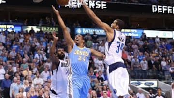 April 12, 2013; Dallas, TX, USA; Denver Nuggets guard Andre Miller (24) shoots against Dallas Mavericks guard O.J. Mayo (32) and forward Brandan Wright (34) at the American Airlines Center. Mandatory Credit: Matthew Emmons-USA TODAY Sports
