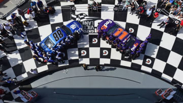 DAYTONA BEACH, FL - FEBRUARY 11: Denny Hamlin, driver of the #11 FedEx Express Toyota, and Alex Bowman, driver of the #88 Nationwide Chevrolet, pose for a photo after winning the pole award for the Monster Energy NASCAR Cup Series Daytona 500 at Daytona International Speedway on February 11, 2018 in Daytona Beach, Florida. (Photo by Jared C. Tilton/Getty Images)
