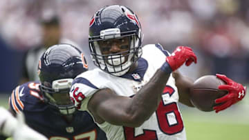 Sep 11, 2016; Houston, TX, USA; Houston Texans running back Lamar Miller (26) runs with the ball during the third quarter as Chicago Bears outside linebacker Willie Young (97) attempts to make a tackle at NRG Stadium. The Texans won 23-14. Mandatory Credit: Troy Taormina-USA TODAY Sports