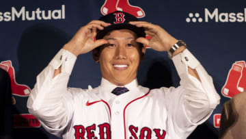 BOSTON, MA - DECEMBER 15: Masataka Yoshida #7 of the Boston Red Sox is presented with a hat and jersey during a press conference announcing his contract agreement with the Boston Red Sox on December 15, 2022 at Fenway Park in Boston, Massachusetts. (Photo by Billie Weiss/Boston Red Sox/Getty Images)