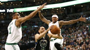 Apr 8, 2016; Boston, MA, USA; Milwaukee Bucks guard Tyler Ennis (11) drives to the hoop against Boston Celtics guard Evan Turner (left) and guard Isaiah Thomas (right) during the first half at TD Garden. Mandatory Credit: Mark L. Baer-USA TODAY Sports