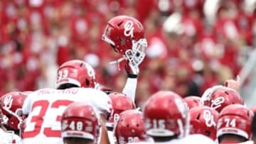 Dec 1, 2012; Ft. Worth, TX, USA; Oklahoma Sooners players huddle and raise a helmet prior to the game against the Texas Christian Horned Frogs at Amon G Carter Stadium. Mandatory Credit: Matthew Emmons-USA TODAY Sports