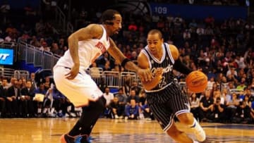 Feb 21, 2014; Orlando, FL, USA; Orlando Magic shooting guard Arron Afflalo (4) drives in front of New York Knicks shooting guard J.R. Smith (8) as the Orlando Magic beat the New York Knicks 129-121 in double overtime at Amway Center. Mandatory Credit: David Manning-USA TODAY Sports