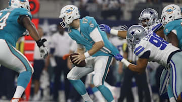 Aug 19, 2016; Arlington, TX, USA; Miami Dolphins quarterback Ryan Tannehill (17) is sacked by Dallas Cowboys defensive tackle Tyrone Crawford (98) in the first quarter at AT&T Stadium. Mandatory Credit: Tim Heitman-USA TODAY Sports