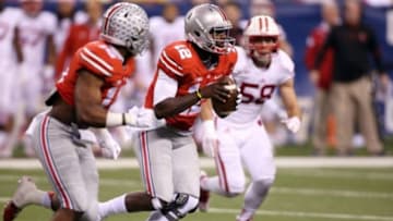 Dec 6, 2014; Indianapolis, IN, USA; Ohio State Buckeyes quarterback Cardale Jones (12) runs with the ball against the Wisconsin Badgers during the Big Ten football championship game at Lucas Oil Stadium. Mandatory Credit: Brian Spurlock-USA TODAY Sports