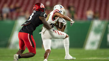 Cincinnati Bearcats safety Ja'Von Hicks tackles South Florida running back at Raymond James Stadium. USA Today.